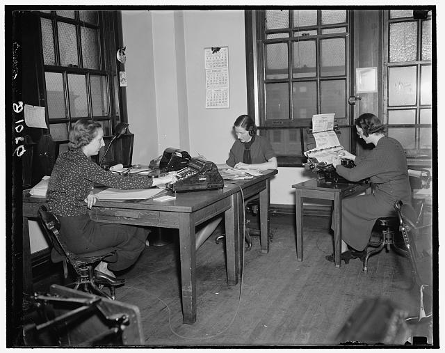 Women working at desks with typewriters