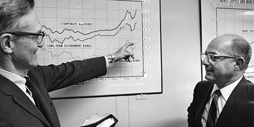 Director of Research Homer Jones discusses yields on government securities with Federal Reserve Bank of St. Louis President Darryl Francis, 1967