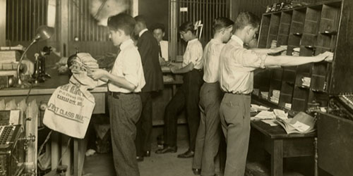 Employees of the St Louis Fed sort and bag bundled checks for transfer, circa 1924. Photo courtesy FRB St. Louis archives.